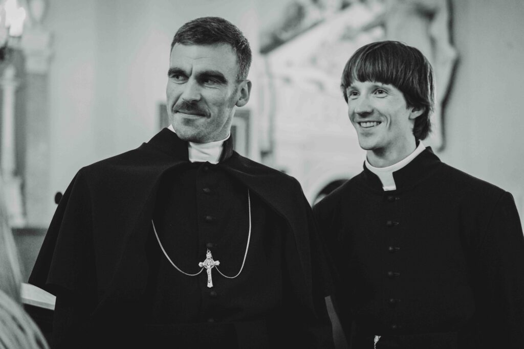 du kunigai baltam juodam fone