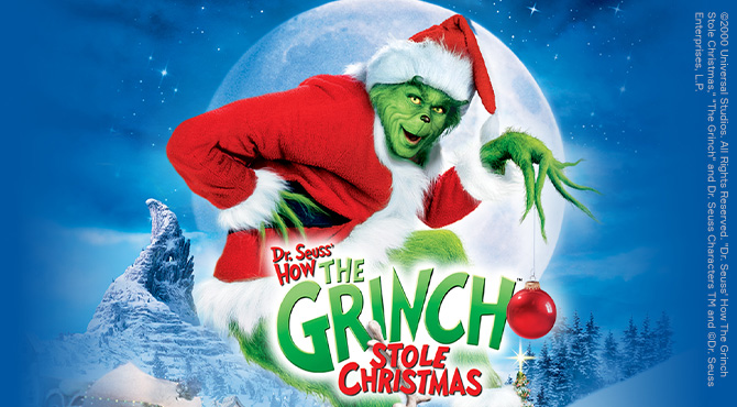 Grinčas, vilkintis Kalėdų Senelio drabužius