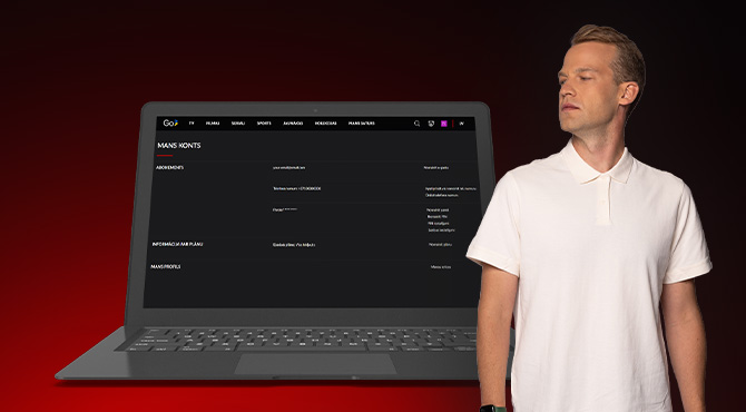 vīrietis skatās uz klēpjdatora sānu